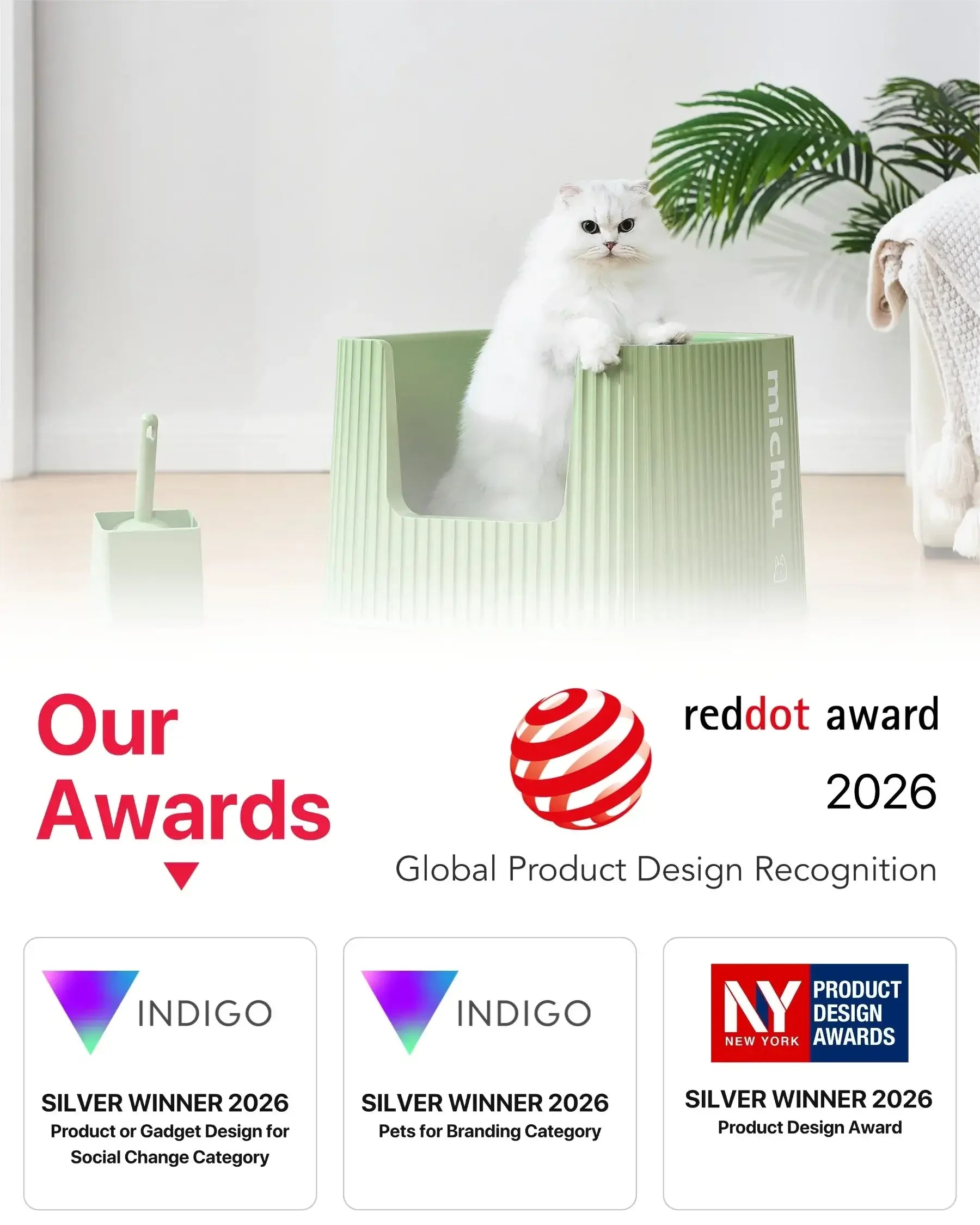 White cat in a light green Michu deluxe cat litter box with design award logos below.