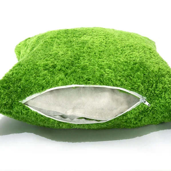 Green textured pillow with a zipper on a white background