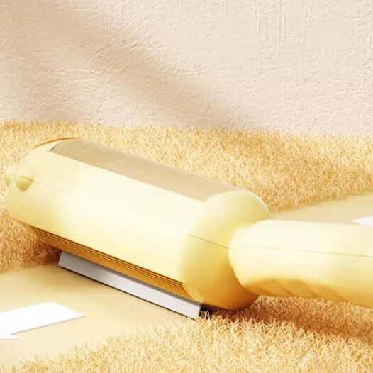 Yellow lint roller on a beige carpet
