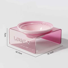 Pink pet bowl with measurements on a light gray background