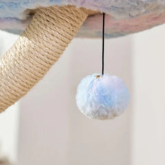 Close-up of a light blue fluffy toy hanging from a Michu fairy cat tower with a sisal wrapped post.