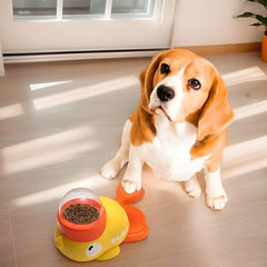 Beagle dog with yellow duck-shaped slow feeder bowl filled with dry kibble on wooden floor