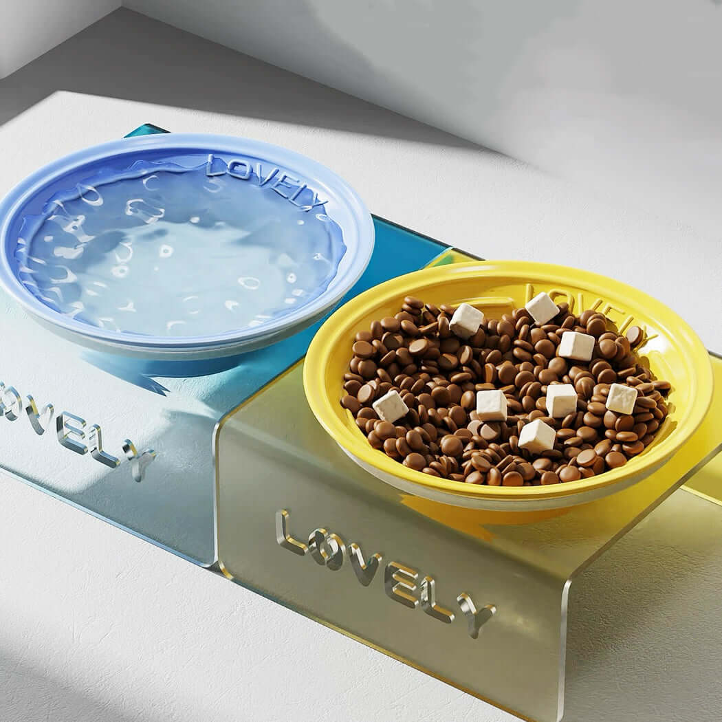 Pet food and water bowl set with 'Lovely' branding on a white surface.