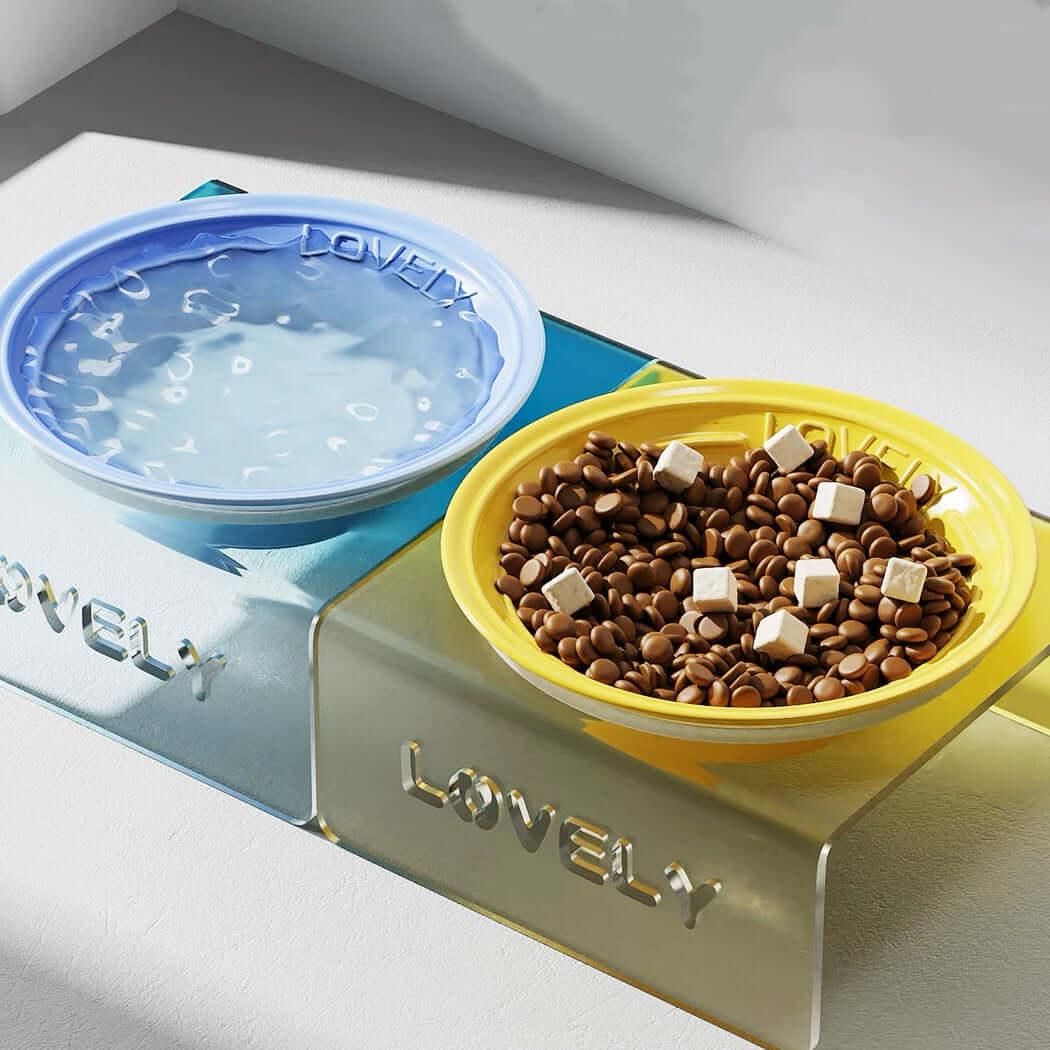 Pet food and water bowl set with 'Lovely' branding on a white surface.