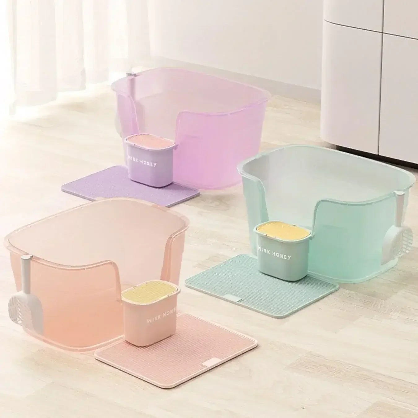 Pastel cat litter boxes with matching mats and scoops, stylish pet supplies for home