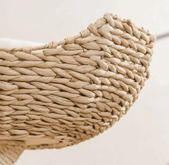 Handwoven natural fiber pet bed with soft cushion, ideal for cats and dogs