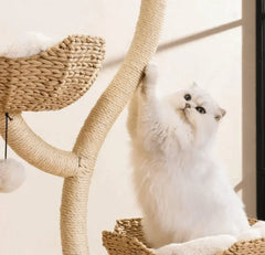 Fluffy white cat playing on a woven wicker cat tree with sisal scratching posts, perfect for indoor cats.