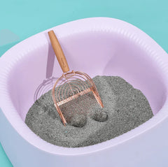 Stainless Steel Cat Litter Scoop Michu - 2 Styles in a litter box with gray litter and a rose gold scoop.