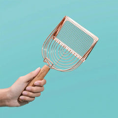 Stainless Steel Cat Litter Scoop Michu - 2 Styles held in a hand with a rose gold finish against a teal background.