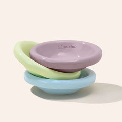 Michu Wide and Shallow Ceramic Pet Bowl in pastel colors stacked together, designed to prevent whisker fatigue for cats.