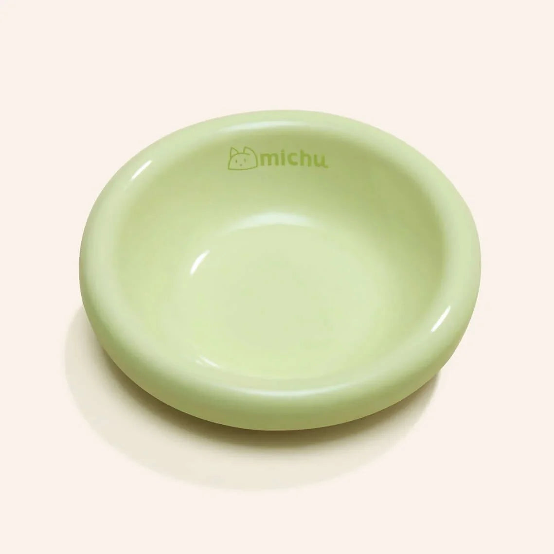 Michu Wide and Shallow Ceramic Pet Bowl in a soft green color, designed for cats to prevent whisker fatigue.