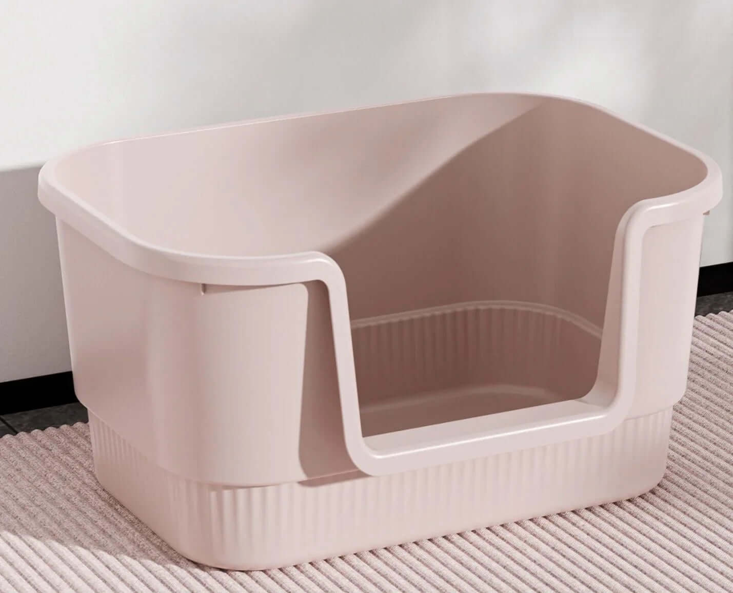 Pink cat litter box with high sides and entry cutout, ideal for indoor pet hygiene and mess control.