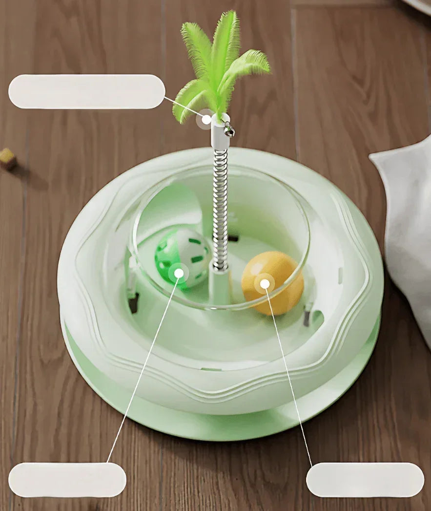 Interactive cat toy with palm tree, spring, and rolling balls on wooden floor