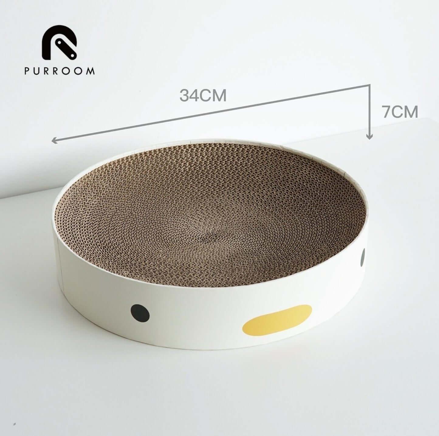 Round cardboard cat scratcher with 34cm diameter, white base, black and yellow dots, ideal for cats to scratch and play.