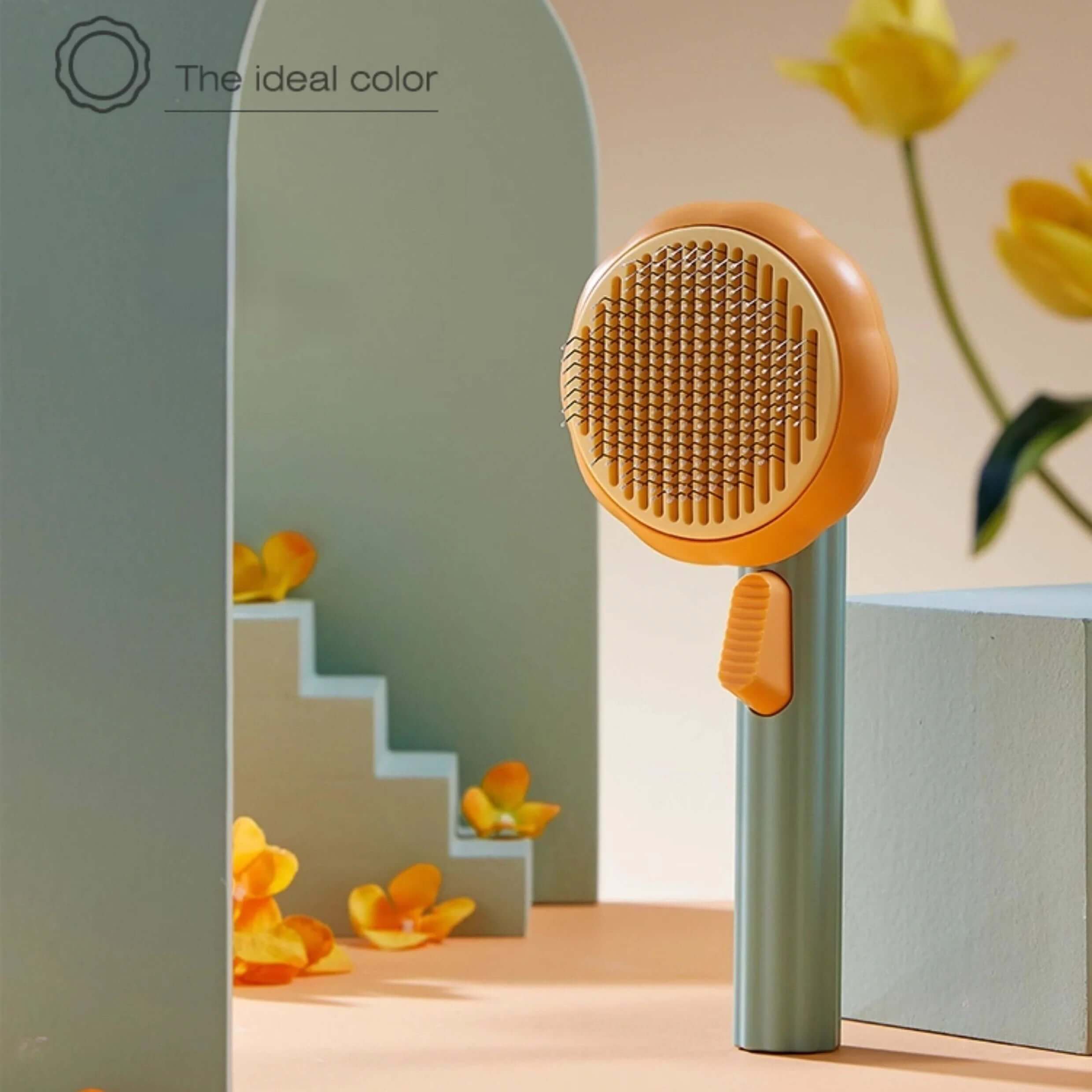 AIWO Pet Grooming Brush Pumpkin Style displayed in a vibrant, colorful setting with floral accents.