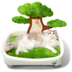 Cat lying on a green-themed pet bed with a tree decoration