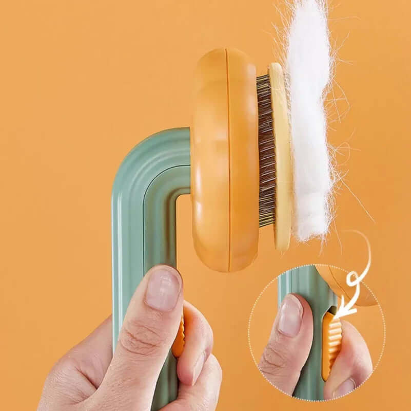Handheld grooming brush with a close-up of bristles and fur on an orange background