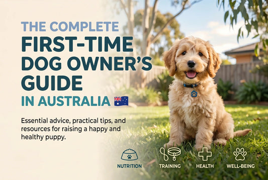 A golden puppy sitting on grass next to 'The Complete First-Time Dog Owner's Guide in Australia'.