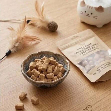 PawDry Freeze-Dried Duck Raw Meaty Bone (RMB) 100g in a bowl next to a pet treat bag, ideal for cats and dogs.