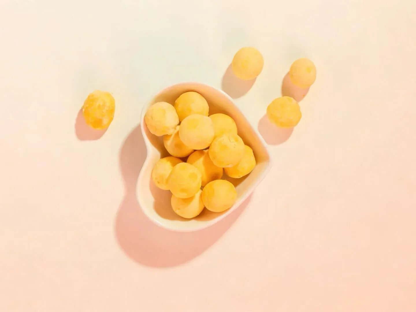 PawDry Freeze-Dried Quail Egg Yolk 100g in heart-shaped bowl, nutrient-dense cat treats.