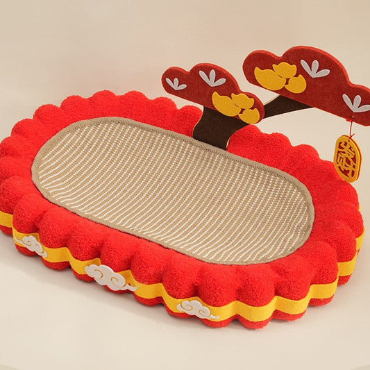 Red and yellow pet bed with a scratching surface on a beige background