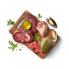 Animals Like Us RawMix50 with Grass-Fed Beef All Life Stages featuring fresh raw ingredients on a cutting board.