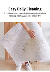 Non-Slip Easy Clean PVC Cat Litter Mat Pink being shaken for easy cleaning, demonstrating simple maintenance.