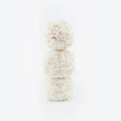 Three white, textured pet treats stacked vertically on white background
