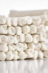 Stacked white dog chew treats for dental care and training